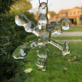 Fused glass snowflake with snowy accents on window